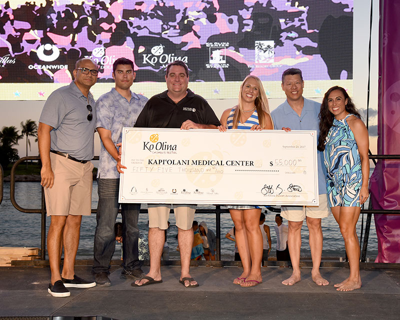 Kapiolani Medical Center team holding donation cheque