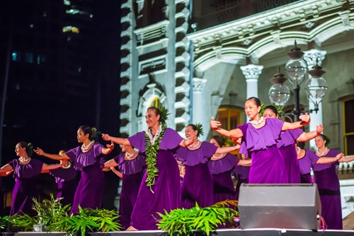 On stage and off, Vicky Holt Takamine is a leader. Here, the kumu hula is seen dancing with her halau Pua Alii Ilima during a performance fronting Iolani Palace in Honolulu.