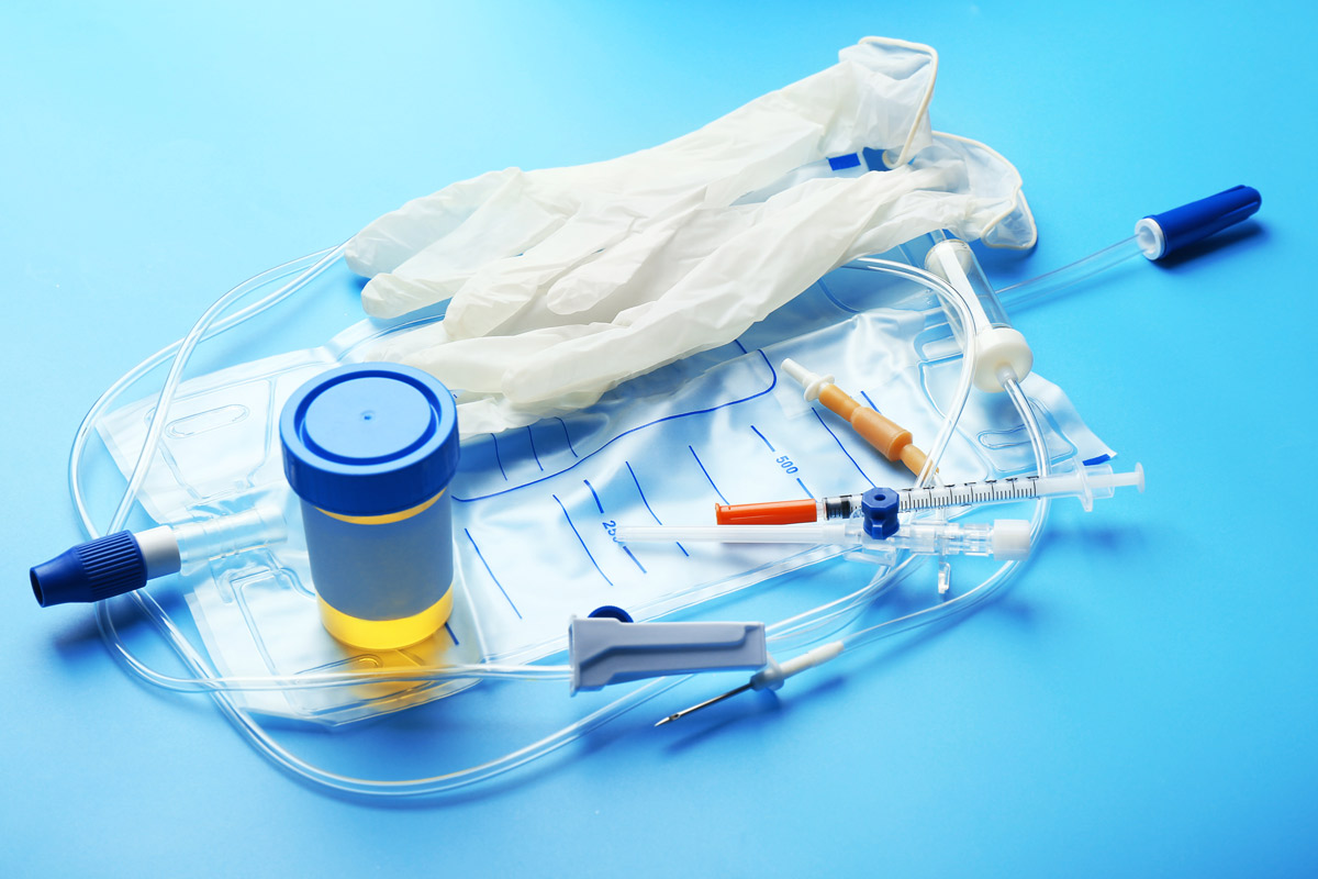An arrangement of medical supplies, including exam gloves, an IV bag, needles and urine sample represent new testing options available for detecting prostate cancer.