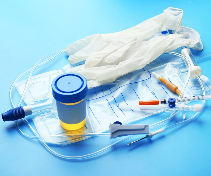 An arrangement of medical supplies, including exam gloves, an IV bag, needles and urine sample represent new testing options available for detecting prostate cancer.