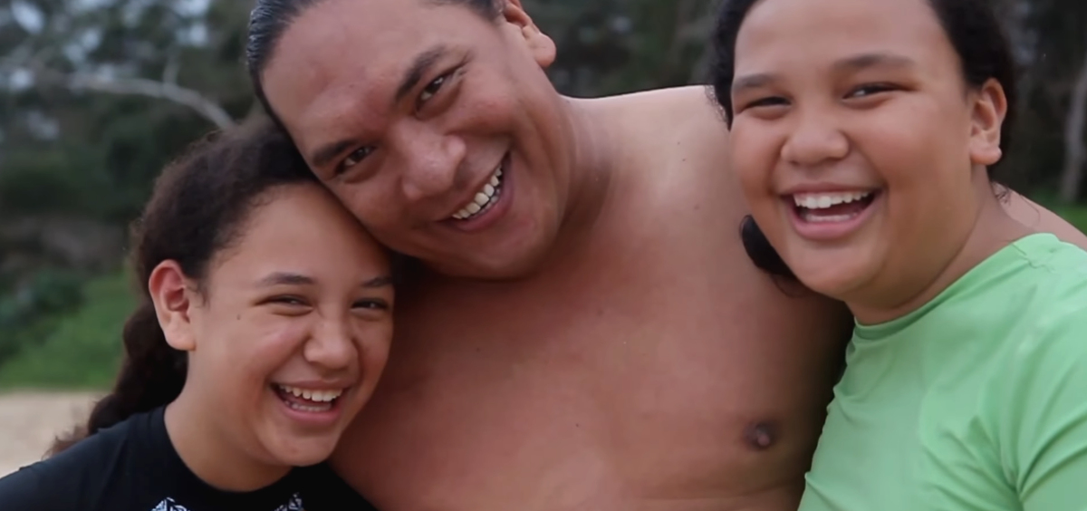 three friends embracing on the beach