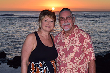 A couple embracing by the beach at sunset