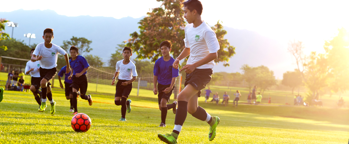 Group of boys playing soccer together