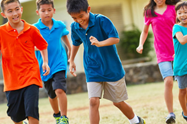 children playing soccer together