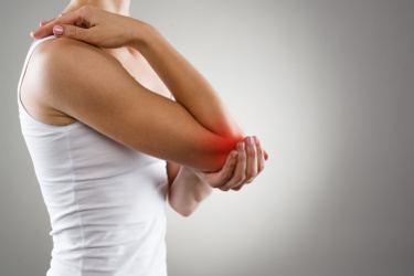 woman holding her arthritic elbow