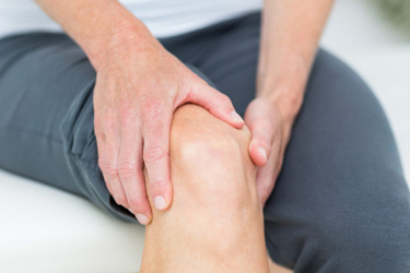 patient holding sore knee