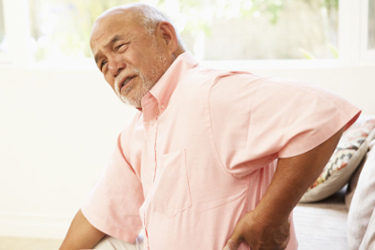 Man clutching sore back