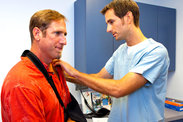 Patient getting physical therapy on his dislocated shoulder