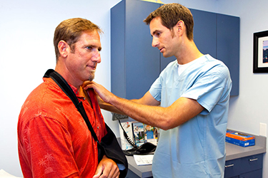 man getting treatment for his dislocated shoulder