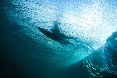 surfer and wave from under the water