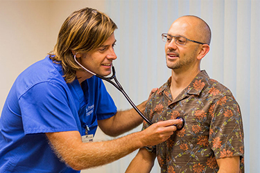 doctor examining his patient with a stethascope