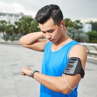 Man checking his watch while running