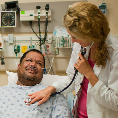 Doctor listening to a patient's heartbeat via stethascope