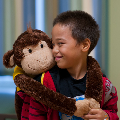 Boy with his stuffed monkey toy