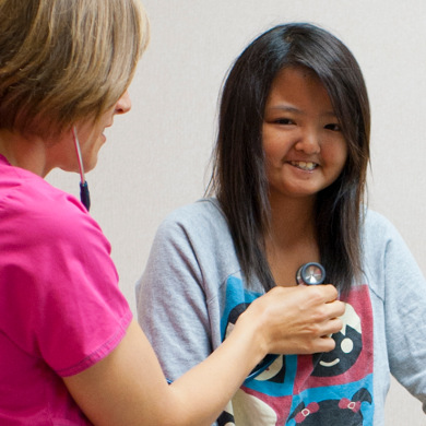 Doctor listening to a patient's heartbeat via stethascope