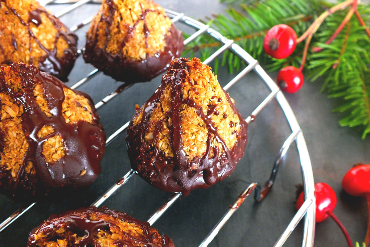 Chocolate-dipped macaroons cool on a wire rack