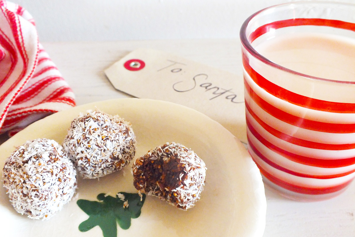 A plate of cookies with a glass of milk and note for Santa