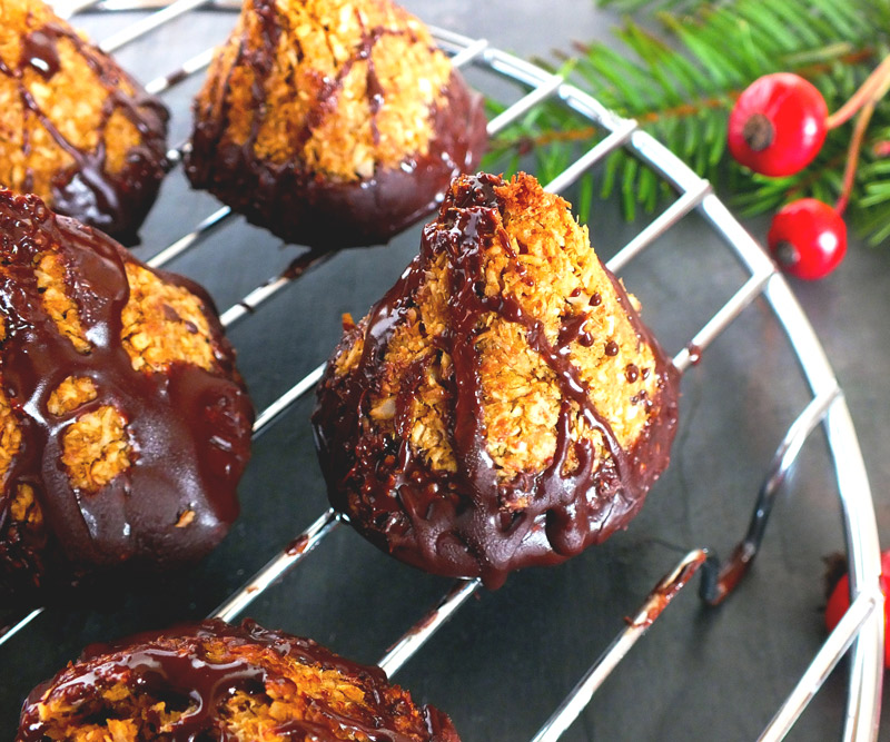 Chocolate-dipped macaroons cool on a wire rack