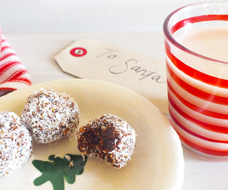 A plate of cookies with a glass of milk and note for Santa