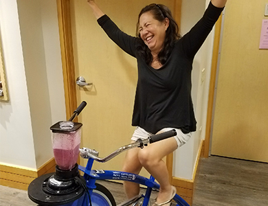 Woman on a bike cheering