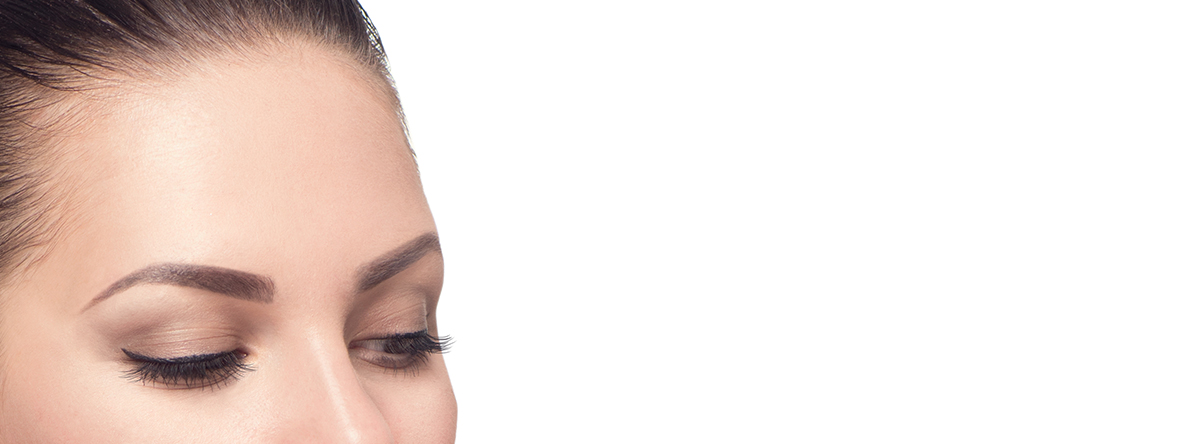 Forehead of a woman with brown hair looking down