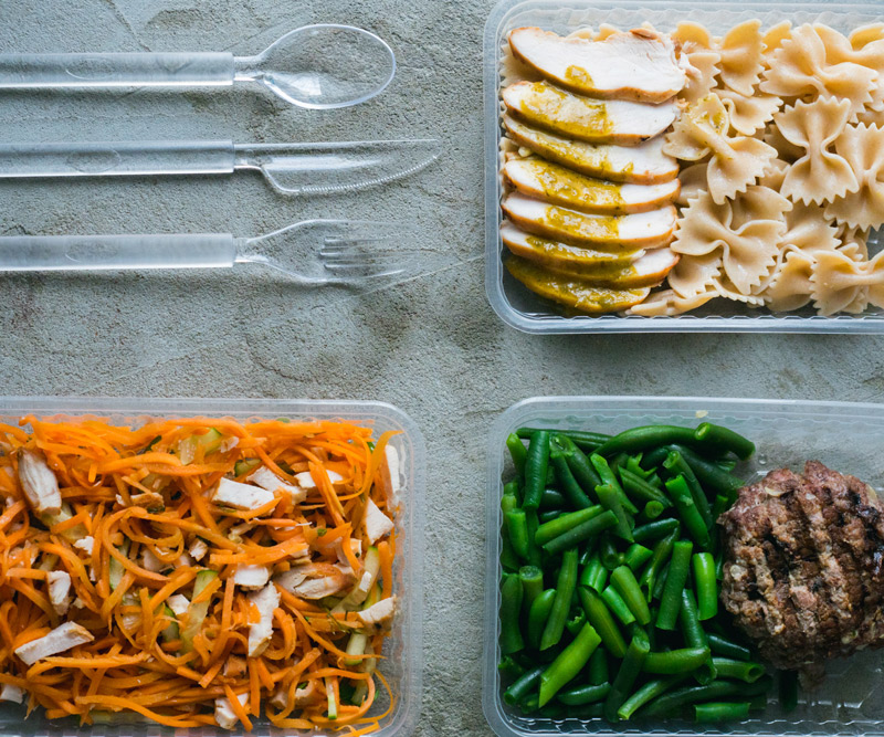 Three meals portioned out into plastic containers