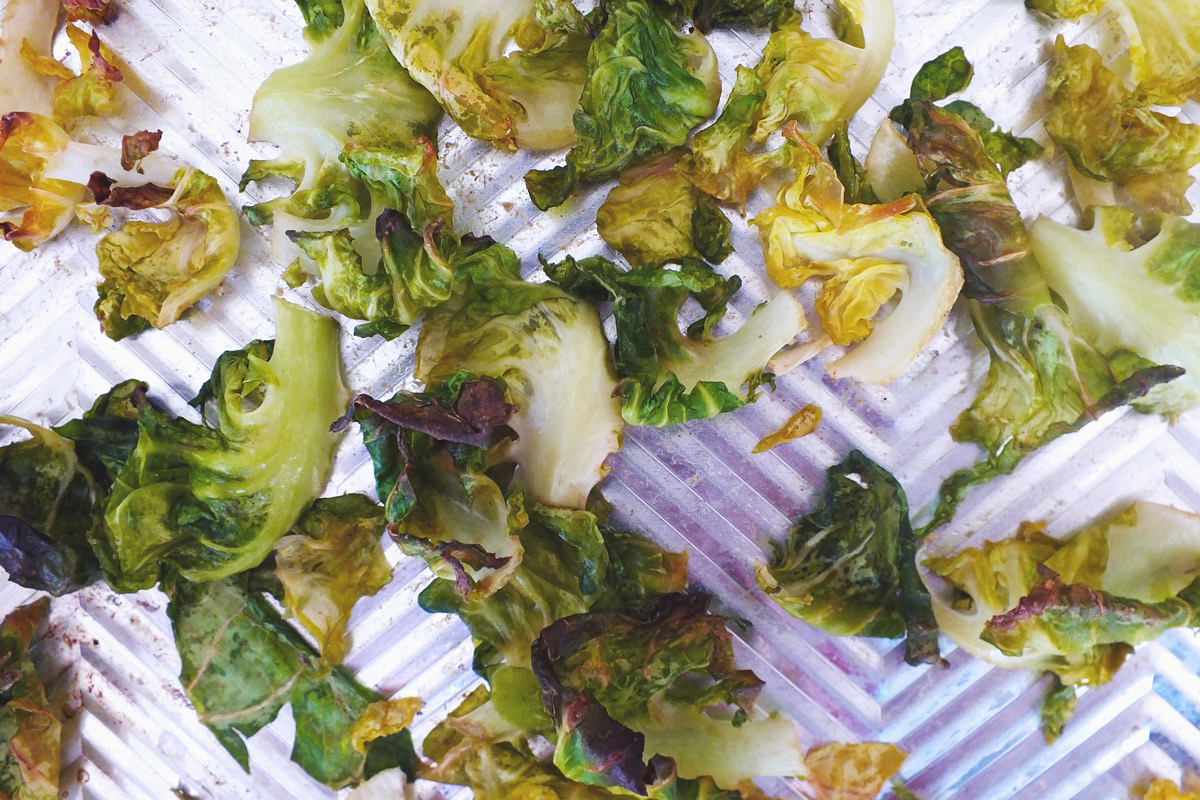 Crispy Brussels Sprout Chips on a baking sheet