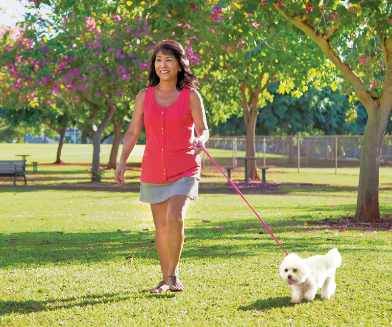 Coleen Uyechi walking her dog in a park