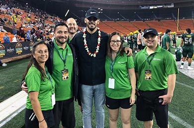 Straub Bone and Joint Team and Marcus Mariota standing in the Aloha Stadium