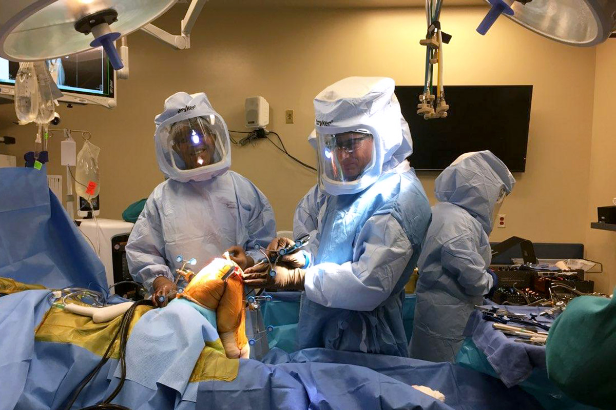Dr. David Rovinksy and Dr. Erik Zeegen perform robotic-assisted total knee replacement surgery on cadavers.