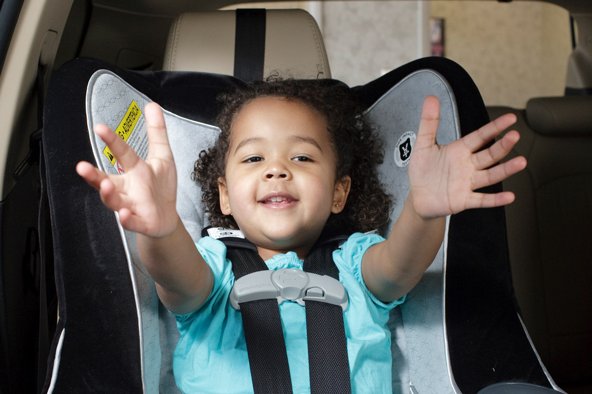 Child sitting in a forward-facing car safety seat