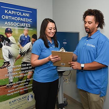 Doctor and physical therapist looking at test results