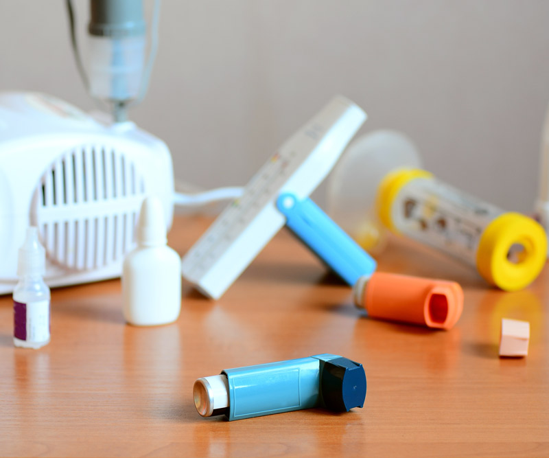 various asthma and allergy treatments on a wooden table