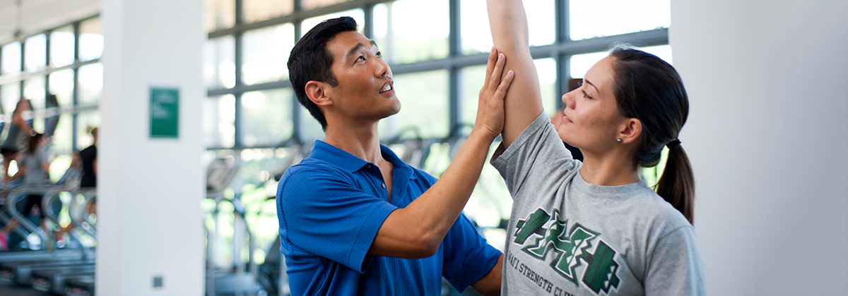 Doctor helping patient to do a physical exercise