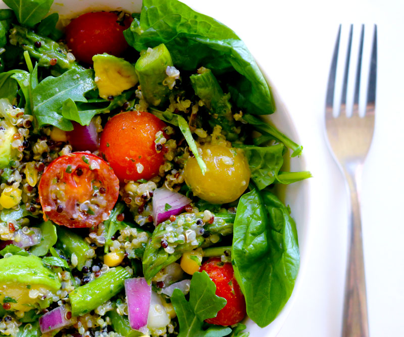 A bowl filled to the brim with Quinoa Salad with Summer Vegetables