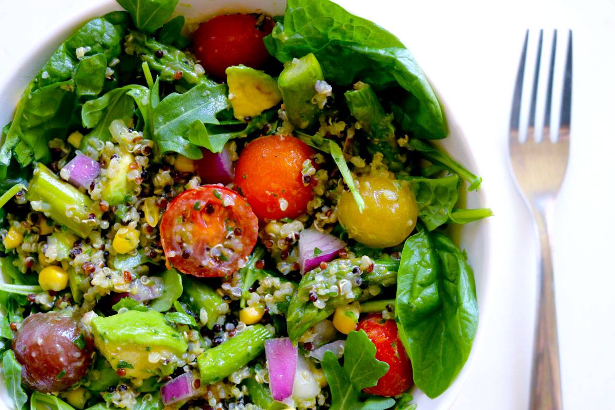 A bowl filled to the brim with Quinoa Salad with Summer Vegetables