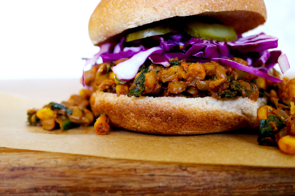 A very sloppily made Lentil Sloppy Joe topped with purple cabbage and pickles