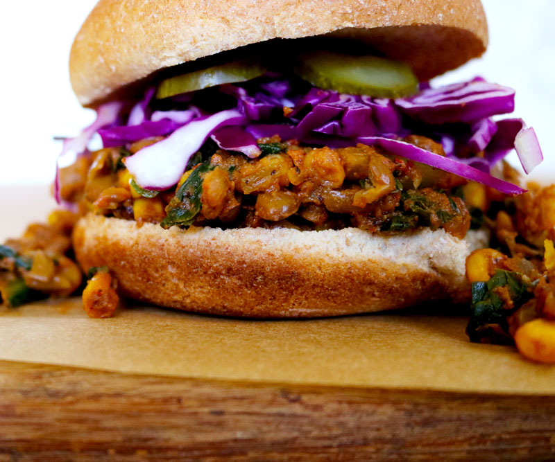 A very sloppily made Lentil Sloppy Joe topped with purple cabbage and pickles