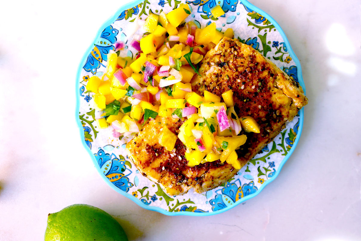 A colorful plate of Cajun-Spiced Mahimahi with Mango Pineapple Salsa