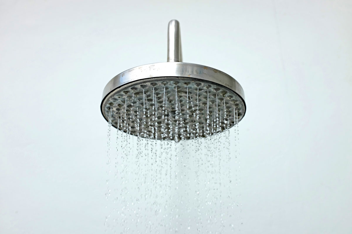 closeup of shower head with running water