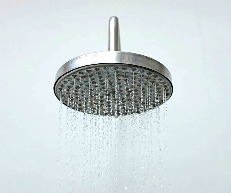 closeup of shower head with running water