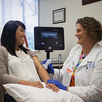 Sports medicine doctor examining patient's elbow