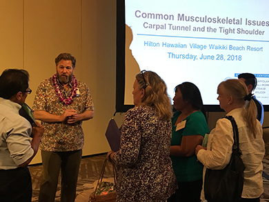 Doctor explaining common musculoskeletal issues to a group of women.