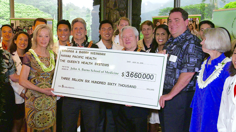 A group of people holding a ceremonial check