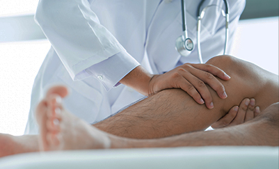 Doctor examining patient's knee