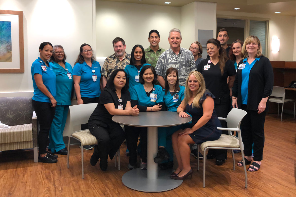 Hawaii News Now "Sunrise on the Road" reporters Dan Cooke, Steve Uyehara and Howard Dicus pose for a group shot with staff members from the Pali Momi Infusion Center