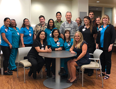 Hawaii News Now "Sunrise on the Road" reporters Dan Cooke, Steve Uyehara and Howard Dicus pose for a group shot with staff members from the Pali Momi Infusion Center