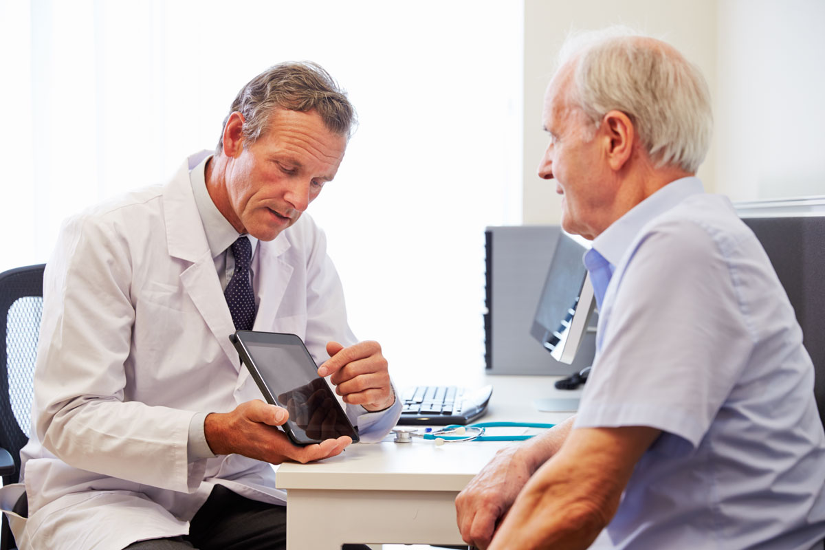 doctor discussing treatment options with elderly man