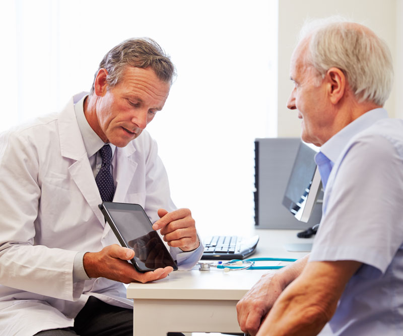 doctor discussing treatment options with elderly man