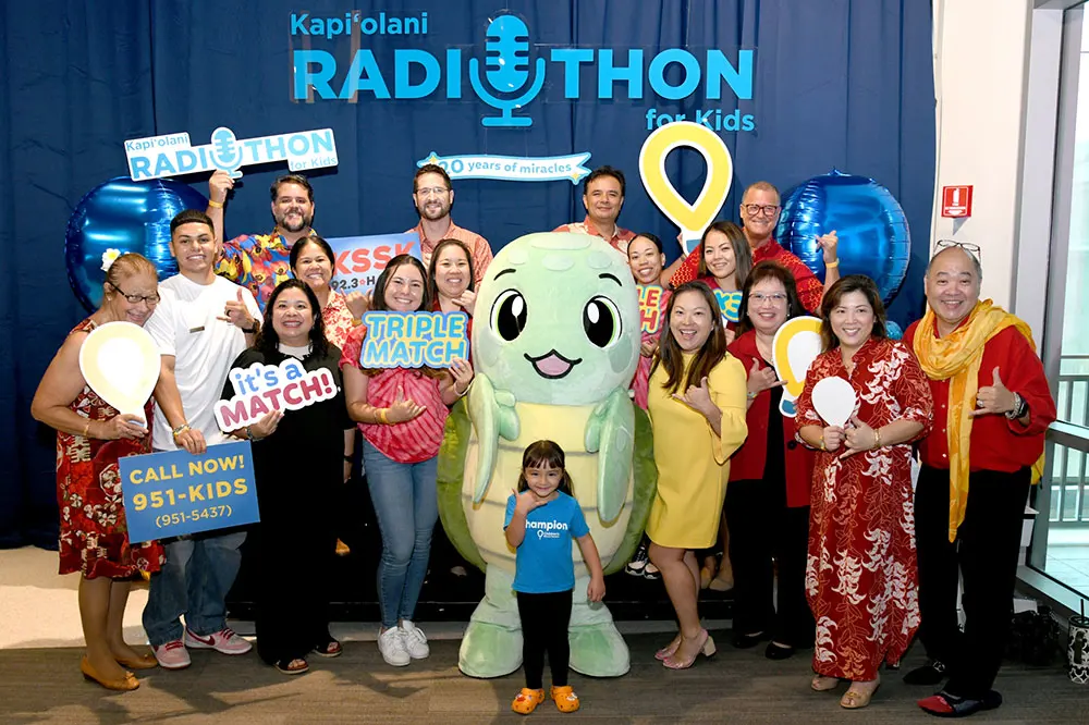 Large group shot of donors and volunteers and a cute life size turtle mascot. 